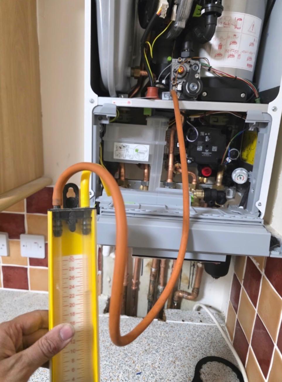 Gas rate manometer test being carried out on an open combi boiler in a Dundee kitchen